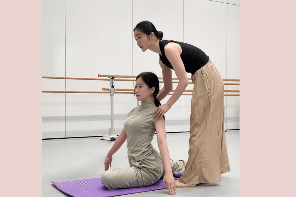 Instructor guiding a student in a one-to-one dance session