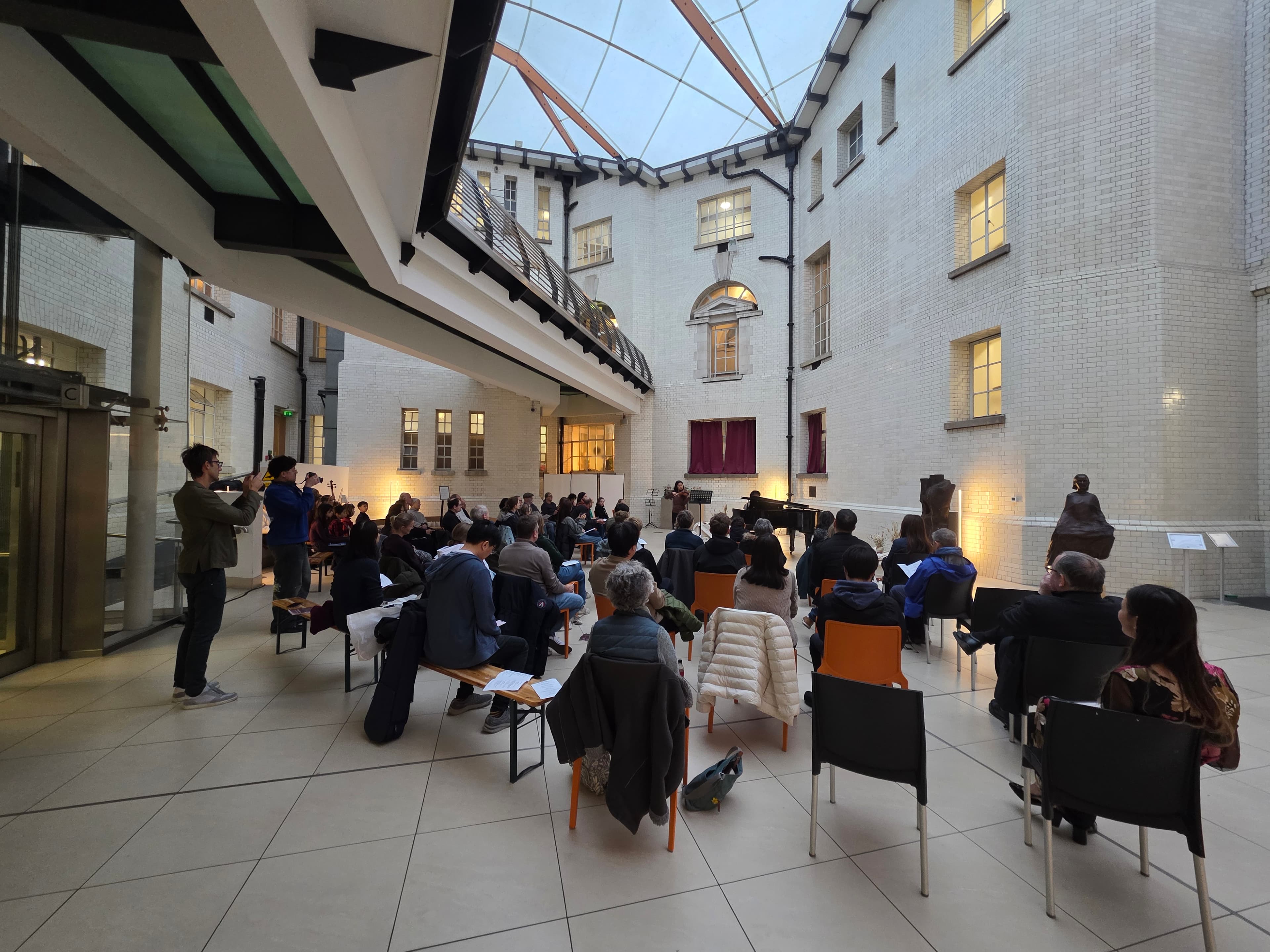 Saxophone and accordion performance beside colourful sculptures at County Hall
